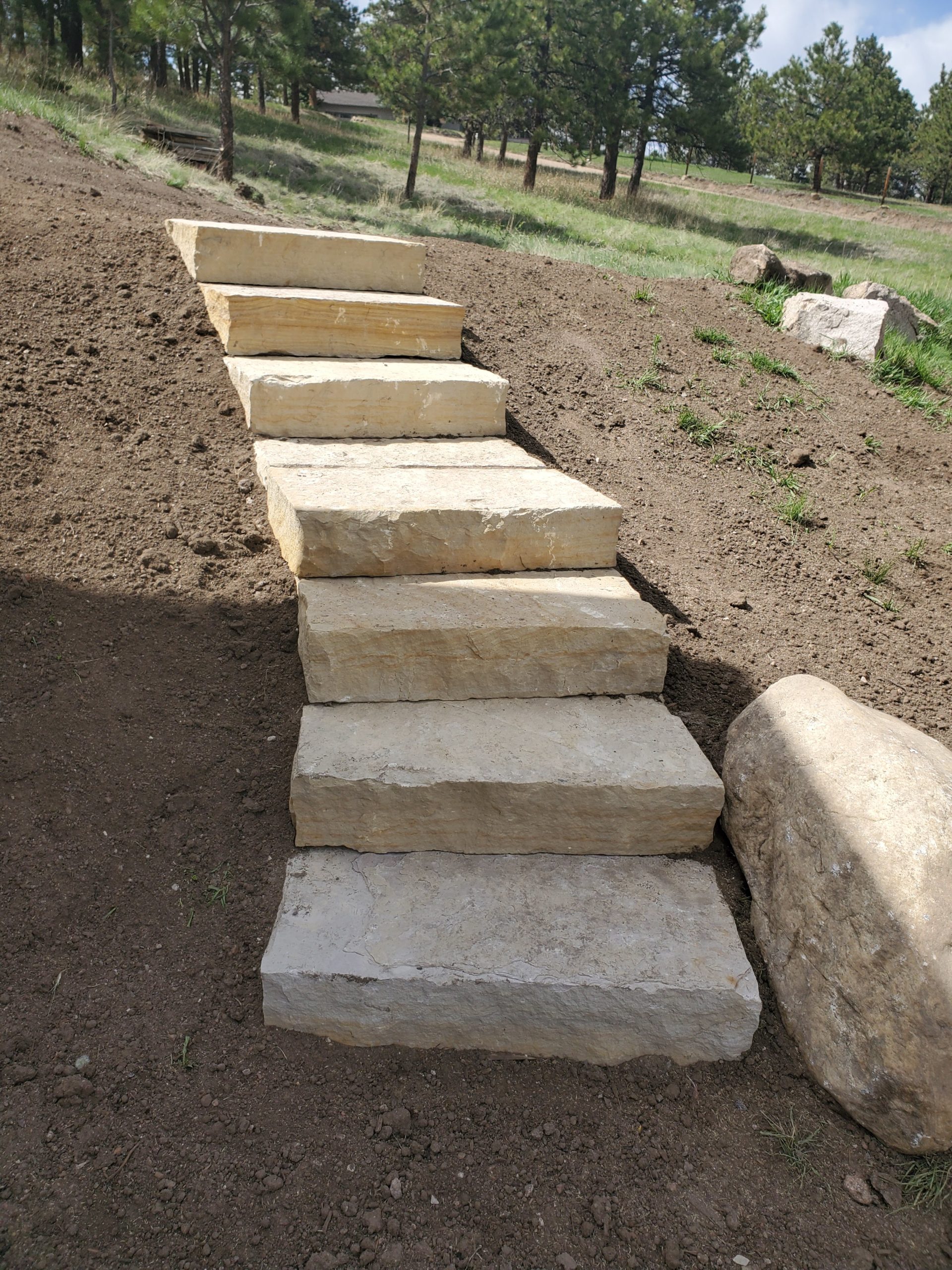 In-progress short staircase made of light-colored stone