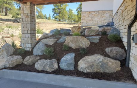 Inset boulders in hill with bushes surrounding them in Boulder, CO