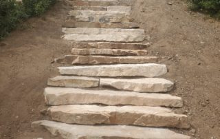 In-progress large stone staircase, leading to house