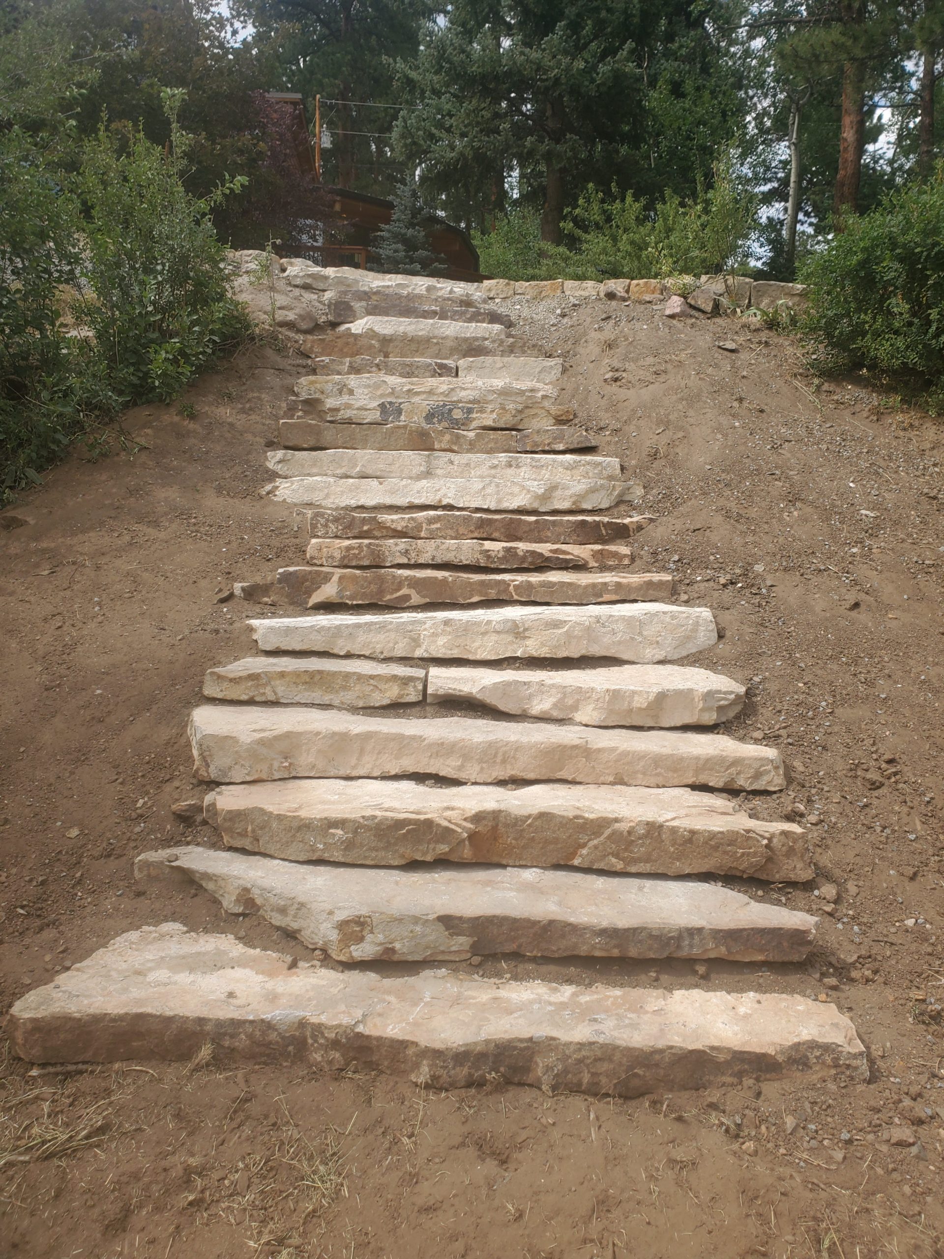 In-progress large stone staircase, leading to house