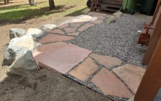 Short flagstone pathway between walk-out and deck.