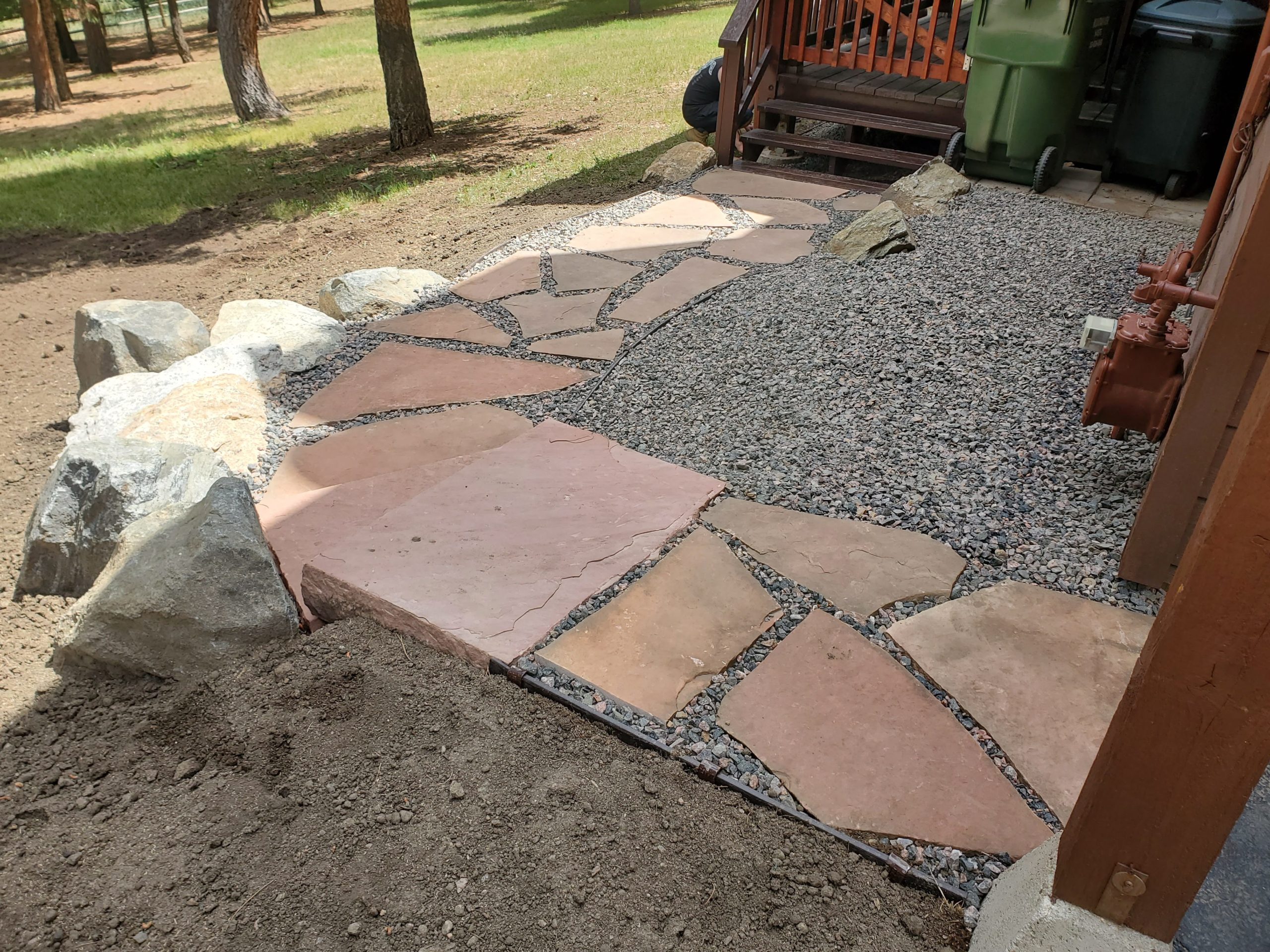 Short flagstone pathway between walk-out and deck.