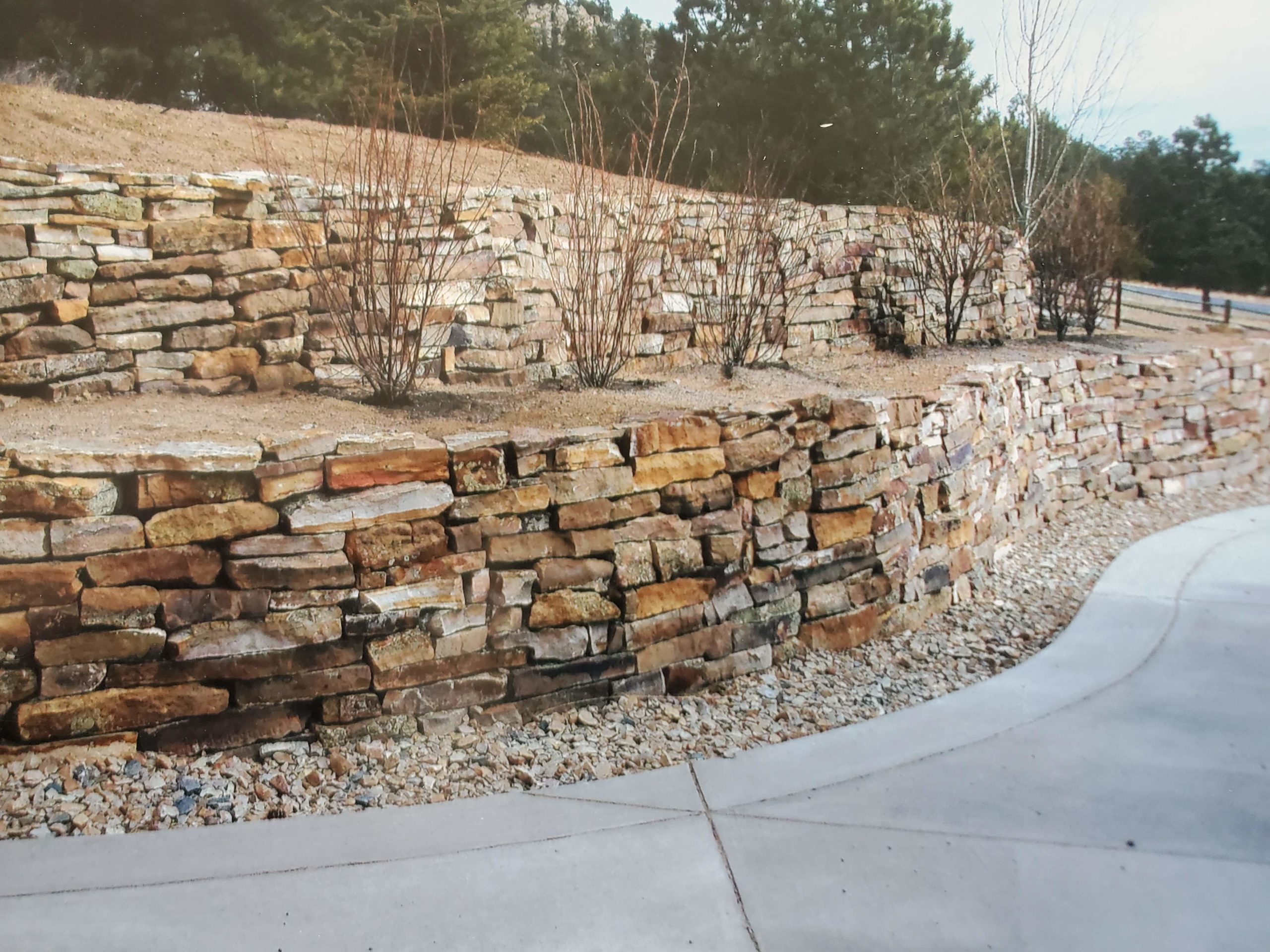 Double-terraced retaining wall with xeriscaping