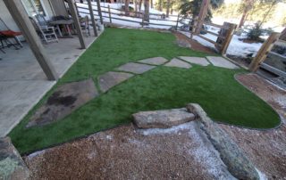 Stone walkway surrounded by grass, near walk-out basement