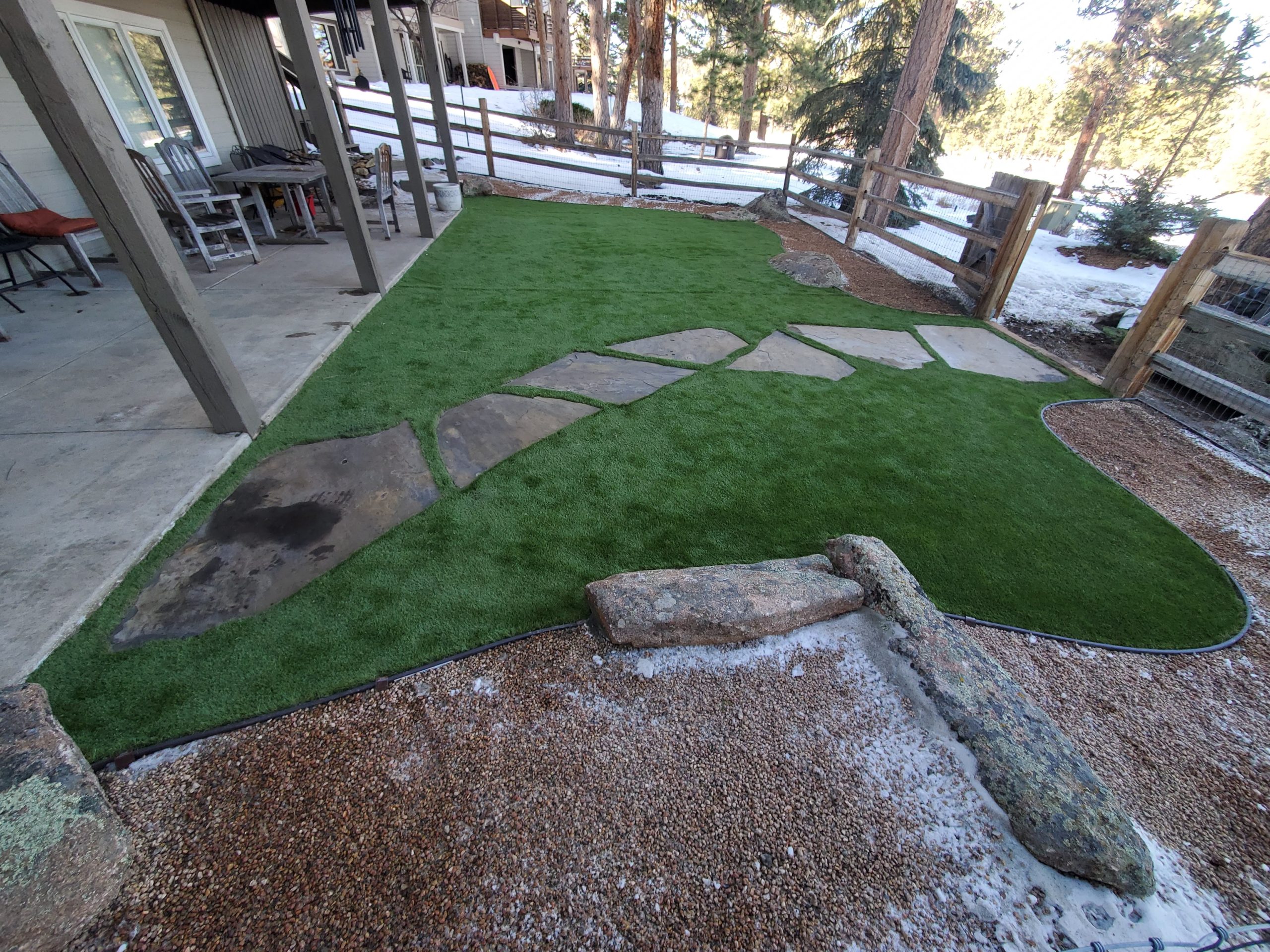 Stone walkway surrounded by grass, near walk-out basement