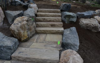 Stone staircase and landing, surrounded by boulders
