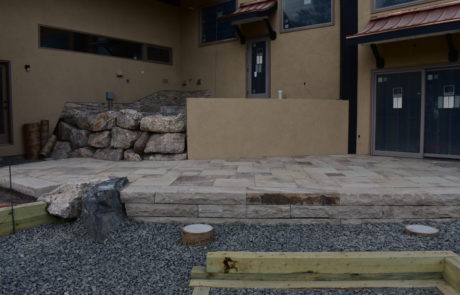 Flagstone patio with step down. Caissons are poured but nothing sits atop them