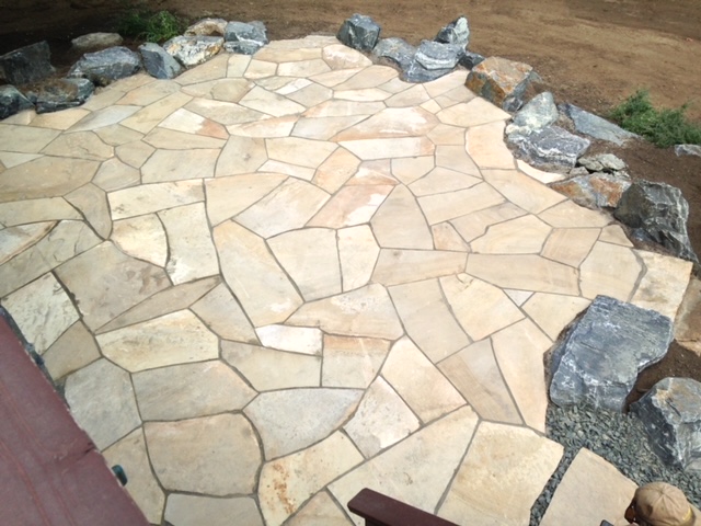 Light-colored stone patio surrounded by stones