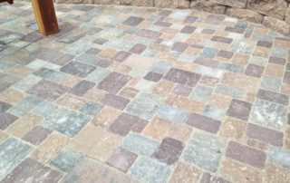 Mosaic of gray, tan, and red stone patio