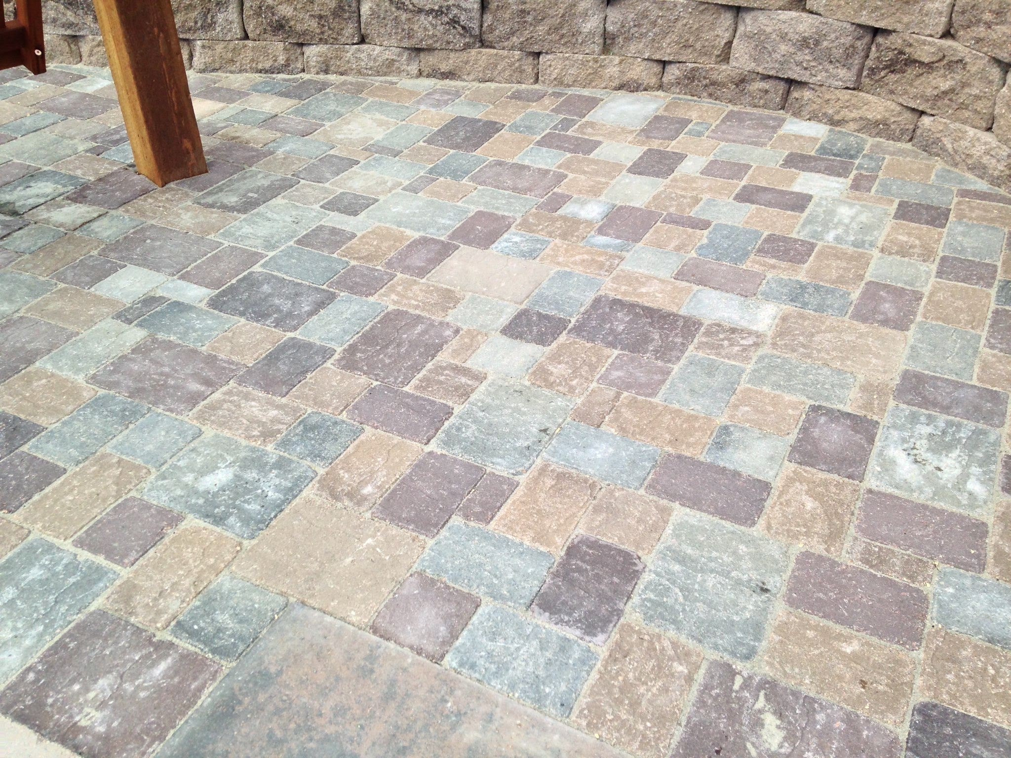 Mosaic of gray, tan, and red stone patio