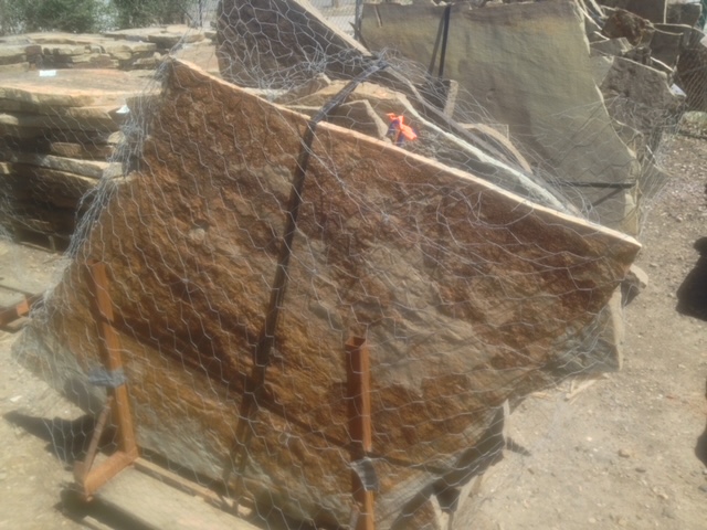 Bulk flagstone on pallet with chicken wire wrapped around it