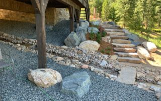 Landscaped streambed or water feature with rock staircase nearby