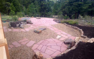 Overview of landscaped backyard with pathways and gravel