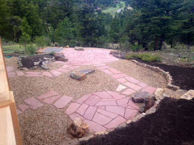 Overview of landscaped backyard with pathways and gravel